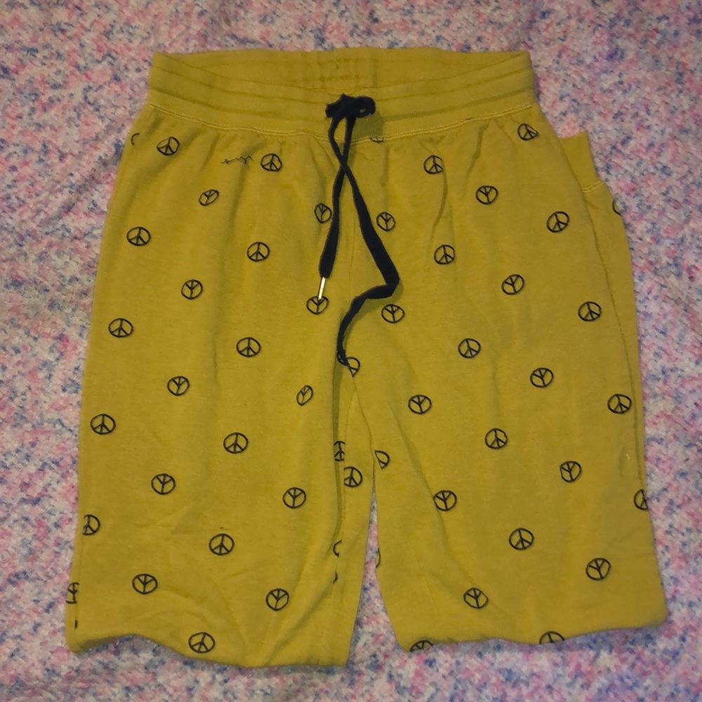 Mustard yellow joggers with navy blue peace sign